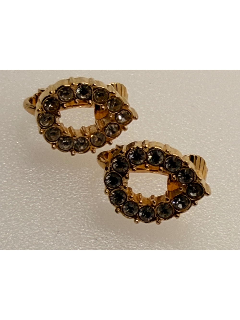Gold tone oval rhinestone clip earrings